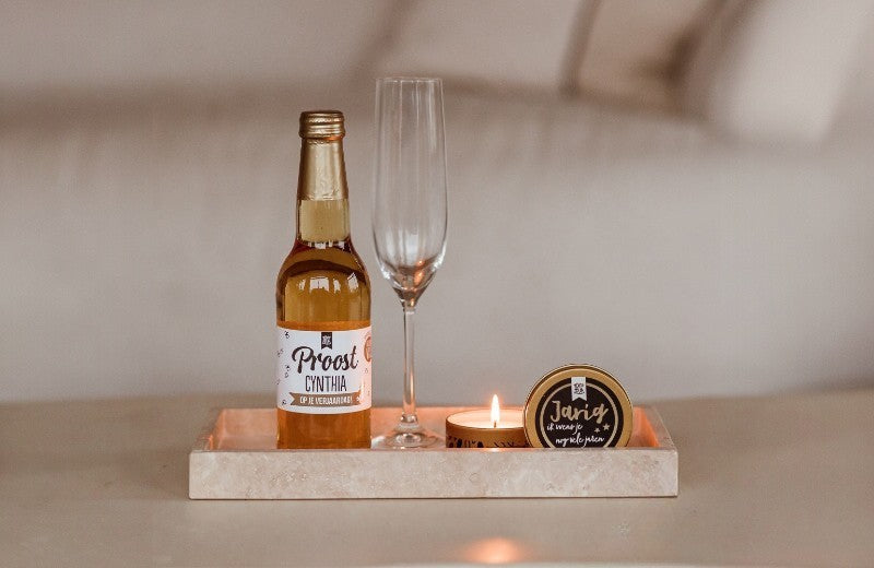 100% Leuk cadeauset – feestelijk flesje bubbels en geurkaars met persoonlijke teksten, perfect om iemand te verrassen en te vieren.